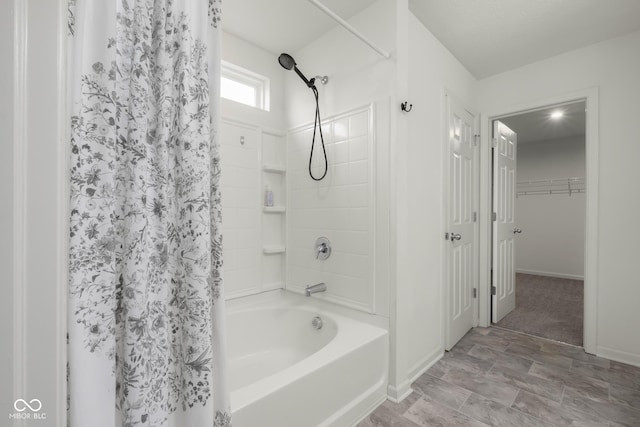 2502 Creekland Dr, Columbus, IN 47201 - bathroom with shower / bath combo, baseboards, and stone finish floors