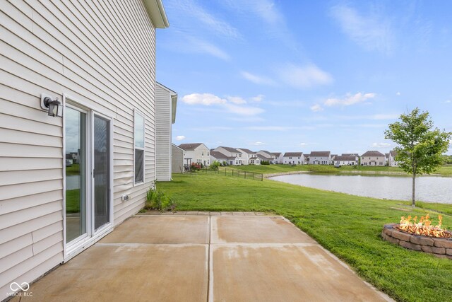 2502 Creekland Dr, Columbus, IN 47201 - view of patio featuring an outdoor fire pit, a water view, and a residential view