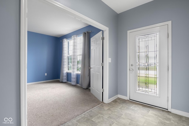 2502 Creekland Dr, Columbus, IN 47201 - entrance foyer featuring baseboards, carpet floors, and stone finish flooring