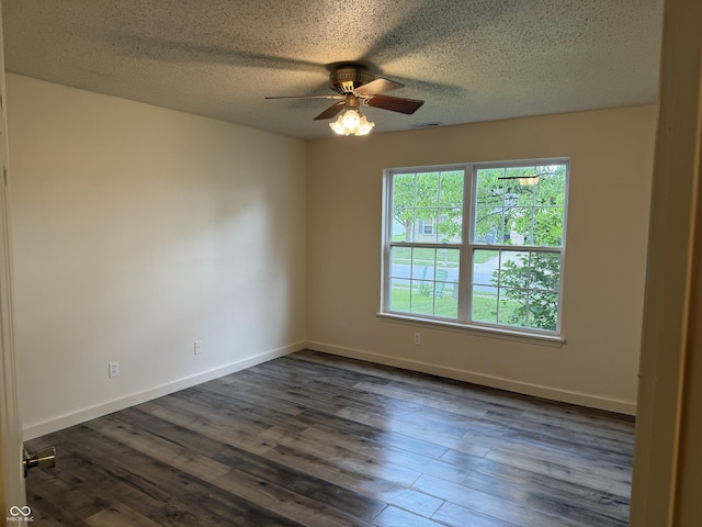 1009 Springwater Rd, Kokomo, IN 46902 - empty room with ceiling fan, dark wood finished floors, a textured ceiling, and baseboards