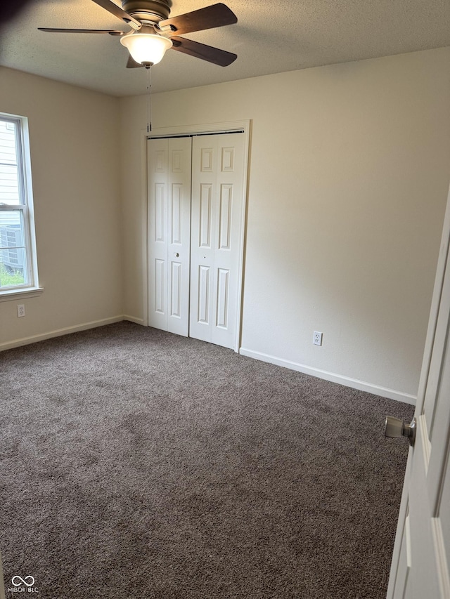 1009 Springwater Rd, Kokomo, IN 46902 - unfurnished bedroom with carpet floors, a closet, baseboards, a ceiling fan, and a textured ceiling