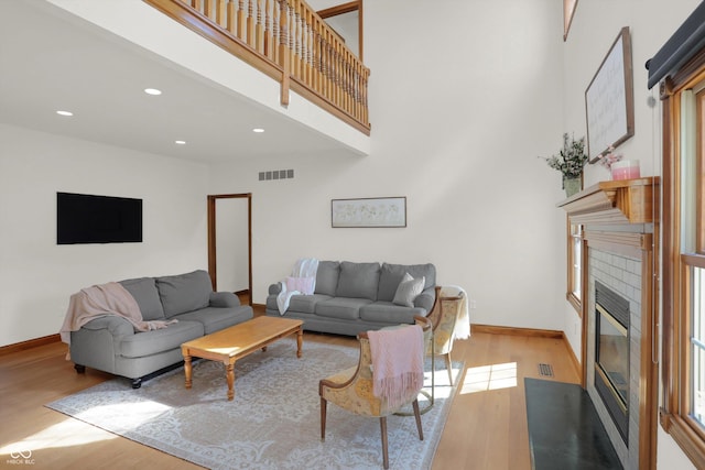 545 Walnut Woods Dr, Greenwood, IN 46142 - living room with wood finished floors, a fireplace with flush hearth, baseboards, and recessed lighting