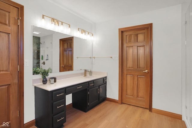545 Walnut Woods Dr, Greenwood, IN 46142 - bathroom featuring wood finished floors, vanity, a shower, and baseboards
