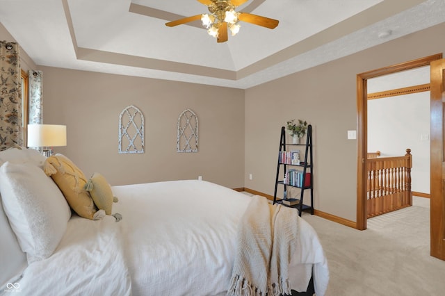 545 Walnut Woods Dr, Greenwood, IN 46142 - bedroom featuring carpet, a tray ceiling, baseboards, and ceiling fan
