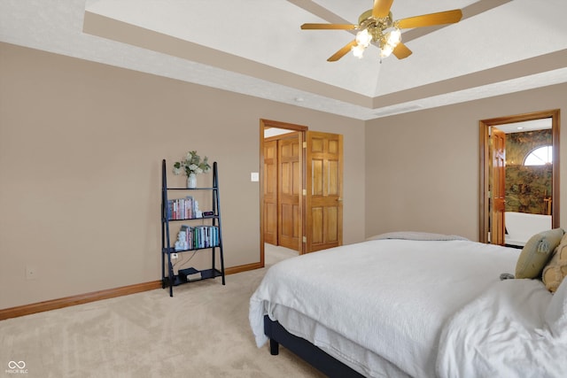 545 Walnut Woods Dr, Greenwood, IN 46142 - bedroom with a raised ceiling, light carpet, baseboards, and a ceiling fan
