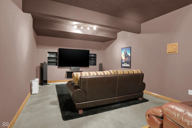 545 Walnut Woods Dr, Greenwood, IN 46142 - home theater room featuring baseboards, finished concrete flooring, and beam ceiling