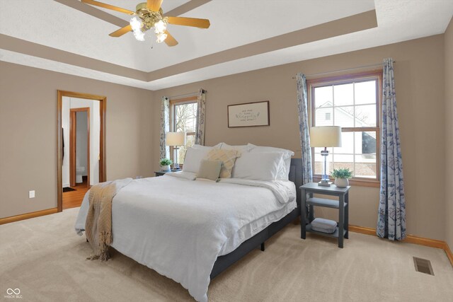 545 Walnut Woods Dr, Greenwood, IN 46142 - carpeted bedroom featuring a raised ceiling, baseboards, and ceiling fan
