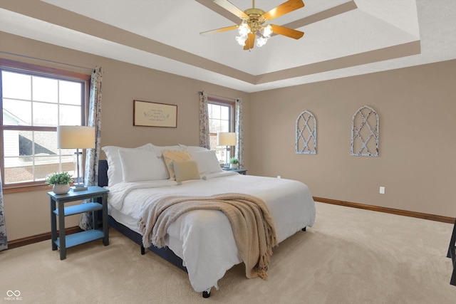 545 Walnut Woods Dr, Greenwood, IN 46142 - bedroom with light colored carpet, baseboards, a raised ceiling, and a ceiling fan