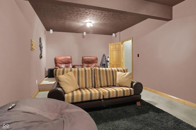 545 Walnut Woods Dr, Greenwood, IN 46142 - home theater room with finished concrete floors, baseboards, and a textured ceiling