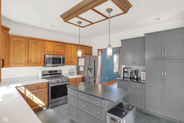 545 Walnut Woods Dr, Greenwood, IN 46142 - kitchen with appliances with stainless steel finishes, dark tile patterned floors, gray cabinetry, hanging light fixtures, and a kitchen island