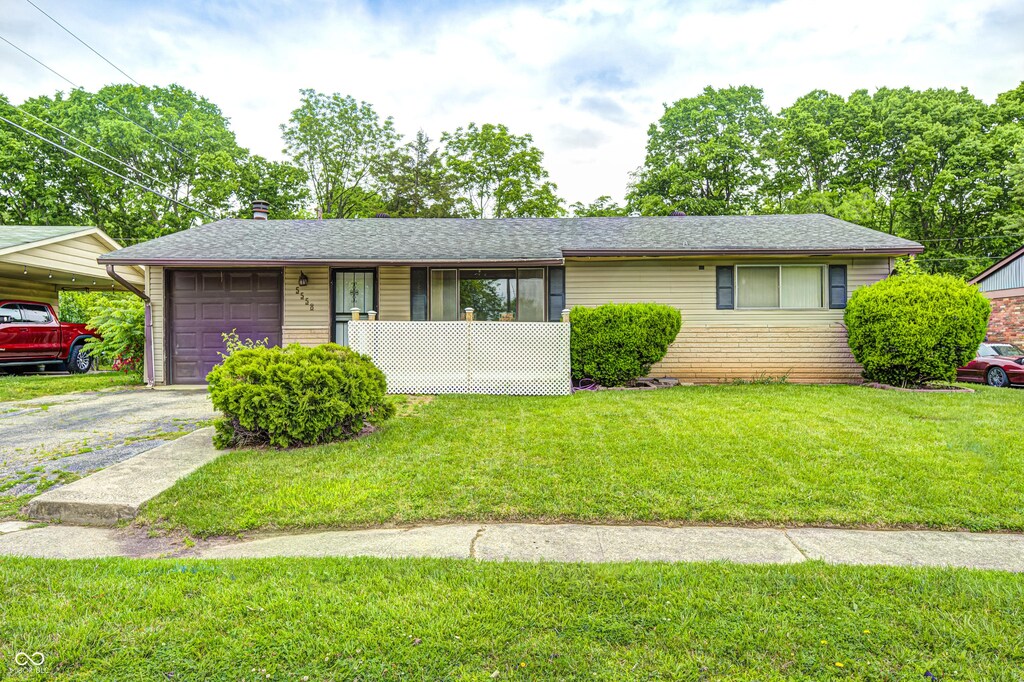 5558 Bertha St, Indianapolis, IN 46241 - ranch-style house featuring a front lawn, asphalt driveway, a shingled roof, and an attached garage