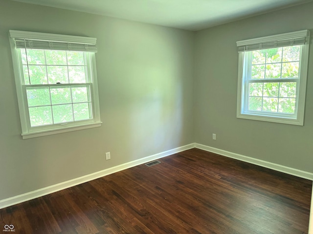10328 Central Ave, Carmel, IN 46280 - spare room with baseboards and dark wood-style floors