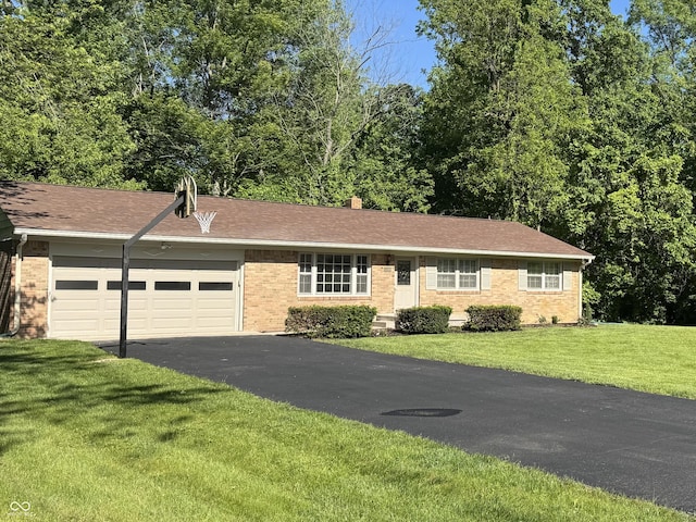 10328 Central Ave, Carmel, IN 46280 - single story home with brick siding, a garage, asphalt driveway, and a front yard