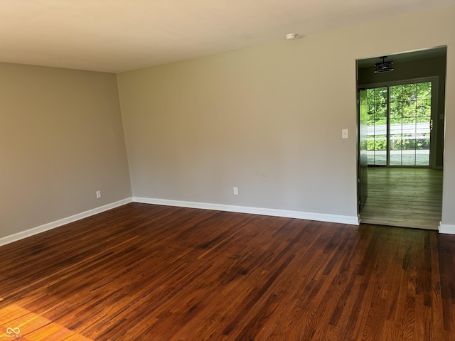 10328 Central Ave, Carmel, IN 46280 - empty room with dark wood-style flooring and baseboards