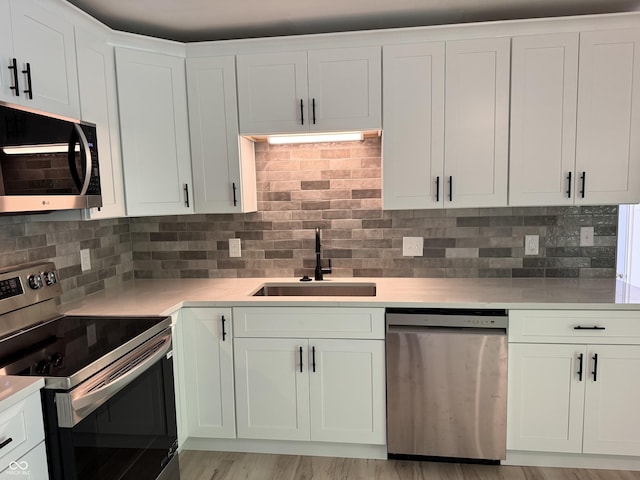 10328 Central Ave, Carmel, IN 46280 - kitchen with appliances with stainless steel finishes, a sink, and light countertops