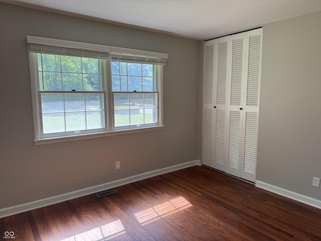 10328 Central Ave, Carmel, IN 46280 - unfurnished bedroom with baseboards, dark wood-type flooring, and a closet