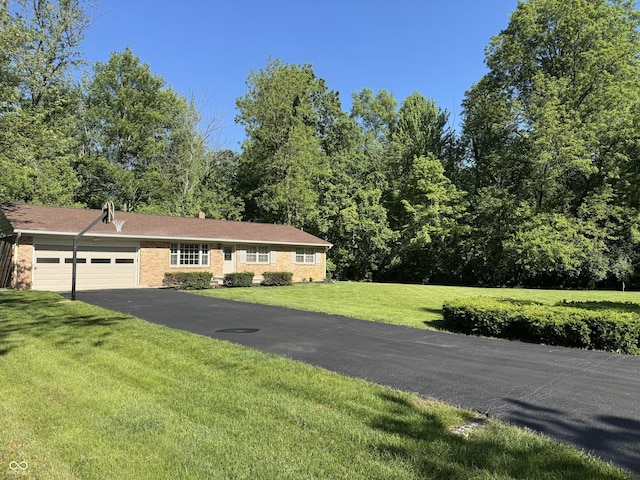 10328 Central Ave, Carmel, IN 46280 - ranch-style house with a garage, asphalt driveway, a front lawn, and brick siding