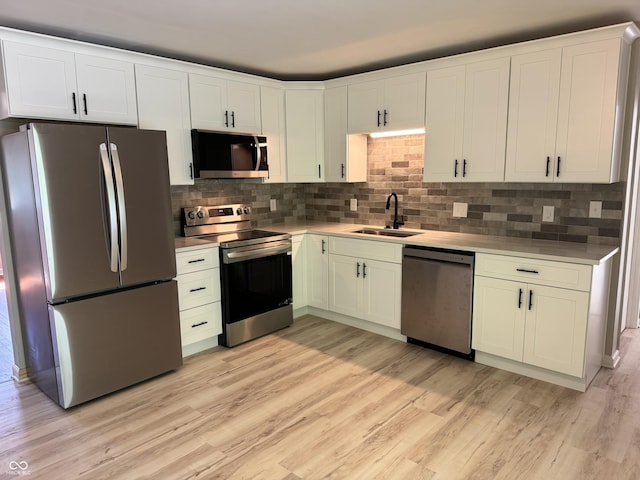 10328 Central Ave, Carmel, IN 46280 - kitchen with stainless steel appliances, a sink, light wood-style flooring, and tasteful backsplash