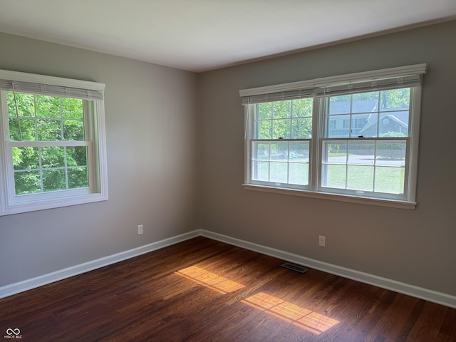 10328 Central Ave, Carmel, IN 46280 - spare room featuring baseboards and dark wood-style flooring