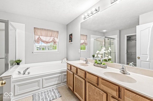 14353 Chariots Whisper Dr, Carmel, IN 46074 - bathroom featuring a shower stall, a garden tub, double vanity, tile patterned floors, and a spacious closet