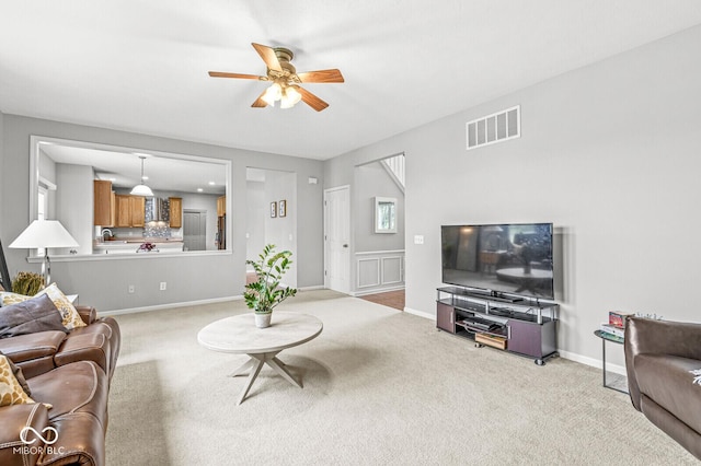 14353 Chariots Whisper Dr, Carmel, IN 46074 - living area with ceiling fan, light colored carpet, and baseboards