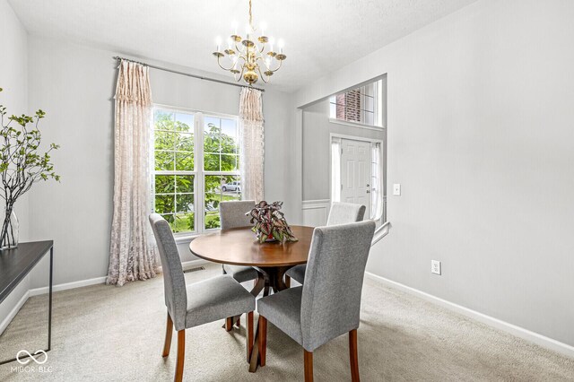 14353 Chariots Whisper Dr, Carmel, IN 46074 - carpeted dining room with a chandelier and baseboards