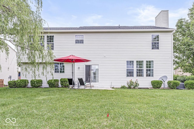 14353 Chariots Whisper Dr, Carmel, IN 46074 - rear view of house featuring a yard and a chimney
