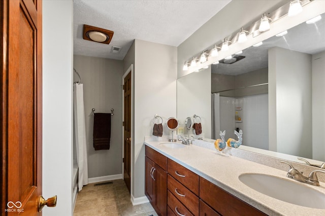 101 Edgewater Dr, Noblesville, IN 46062 - full bathroom featuring double vanity, shower / bathtub combination with curtain, tile patterned flooring, baseboards, and a textured ceiling