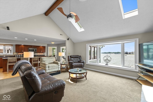 101 Edgewater Dr, Noblesville, IN 46062 - living room with a skylight, light carpet, beam ceiling, plenty of natural light, and ceiling fan