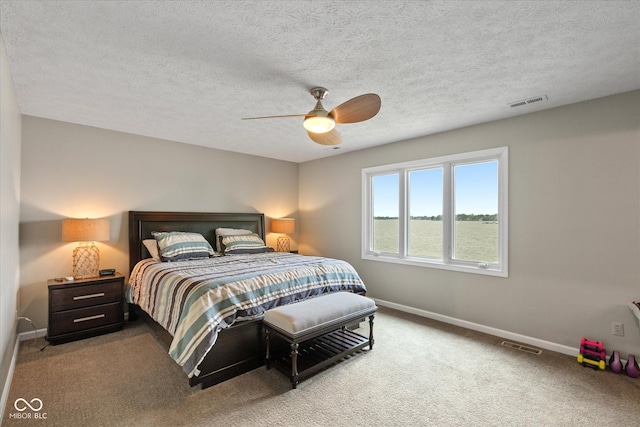 101 Edgewater Dr, Noblesville, IN 46062 - bedroom with baseboards, carpet, a ceiling fan, and a textured ceiling