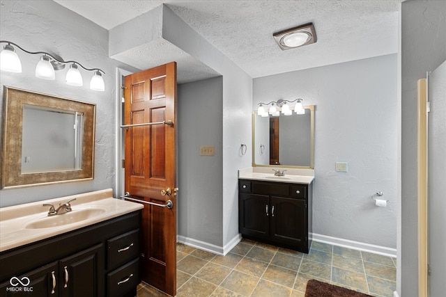 101 Edgewater Dr, Noblesville, IN 46062 - full bathroom featuring two vanities, baseboards, and a textured ceiling