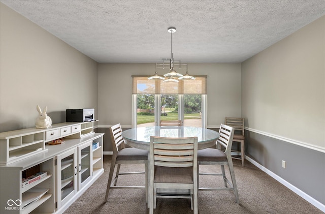 101 Edgewater Dr, Noblesville, IN 46062 - carpeted dining room with a chandelier, baseboards, and a textured ceiling