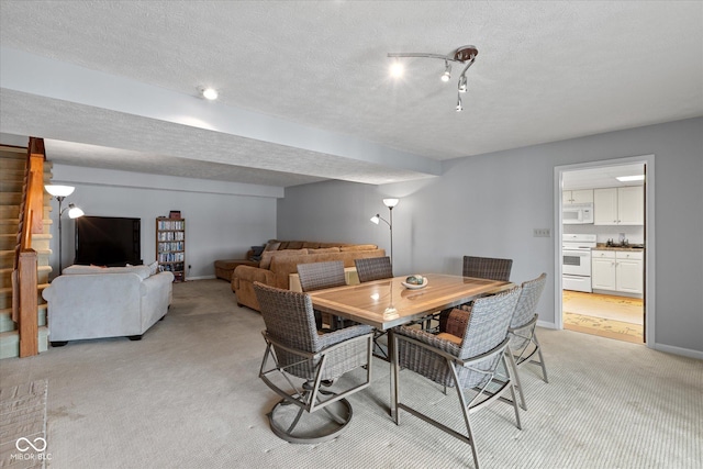 101 Edgewater Dr, Noblesville, IN 46062 - dining area featuring light colored carpet, a textured ceiling, and baseboards
