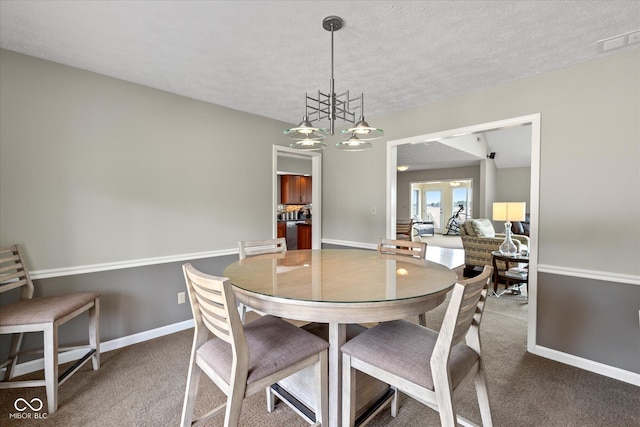 101 Edgewater Dr, Noblesville, IN 46062 - dining room featuring carpet floors, a chandelier, baseboards, and a textured ceiling