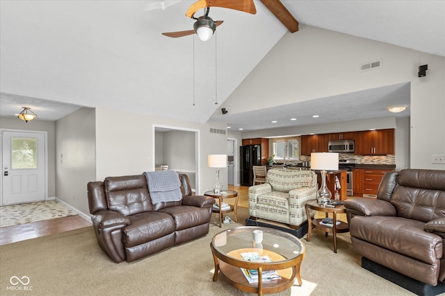 101 Edgewater Dr, Noblesville, IN 46062 - living area with a ceiling fan, beamed ceiling, high vaulted ceiling, light carpet, and baseboards