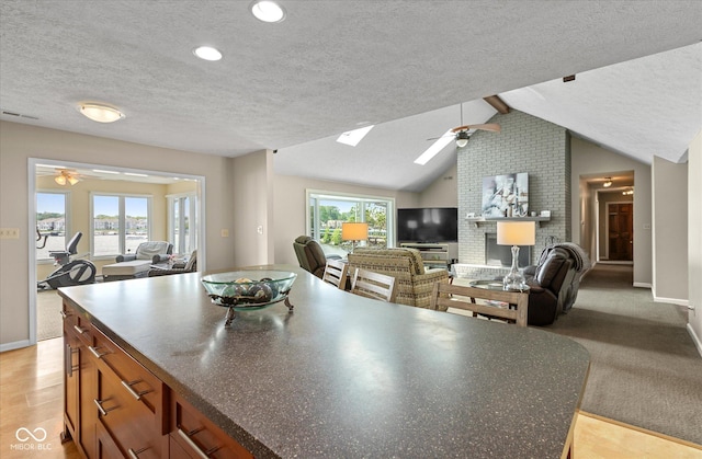 101 Edgewater Dr, Noblesville, IN 46062 - kitchen with ceiling fan, a textured ceiling, open floor plan, and baseboards