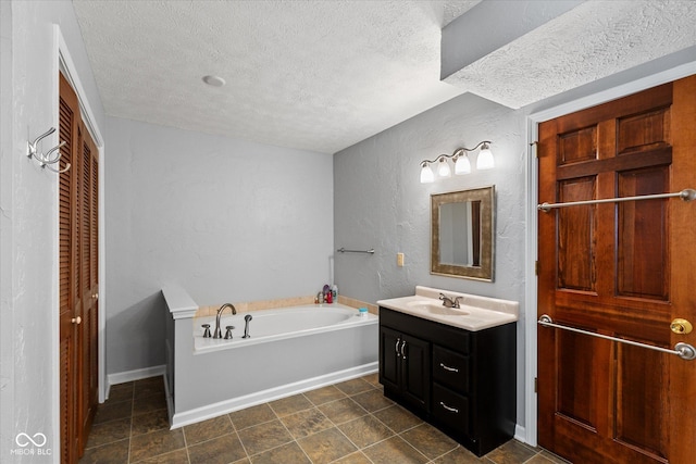 101 Edgewater Dr, Noblesville, IN 46062 - full bathroom with a textured wall, a textured ceiling, vanity, a bath, and baseboards