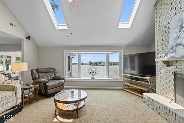 101 Edgewater Dr, Noblesville, IN 46062 - carpeted living area featuring a skylight, vaulted ceiling, healthy amount of natural light, and a fireplace