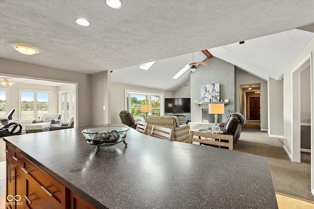 101 Edgewater Dr, Noblesville, IN 46062 - kitchen featuring ceiling fan, open floor plan, a textured ceiling, dark countertops, and lofted ceiling