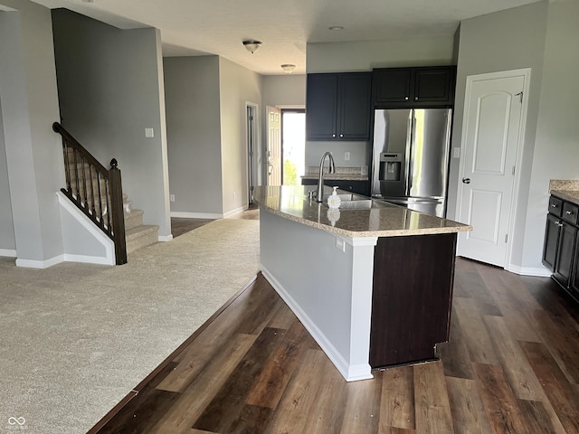 842 Westpointe Dr, Shelbyville, IN 46176 - kitchen featuring stainless steel fridge with ice dispenser, dark wood finished floors, a sink, light stone counters, and baseboards