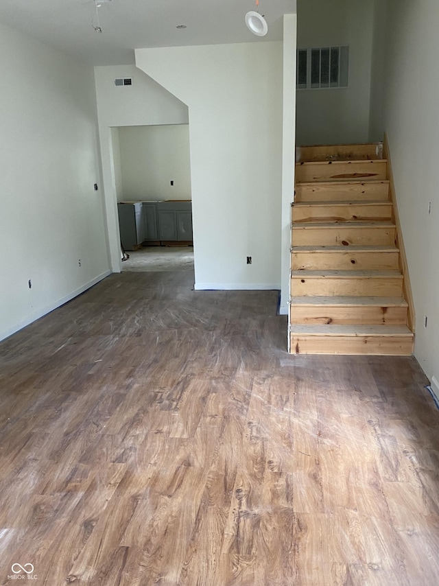 830 Villa Ave, Indianapolis, IN 46203 - unfurnished living room with stairway, wood finished floors, and baseboards