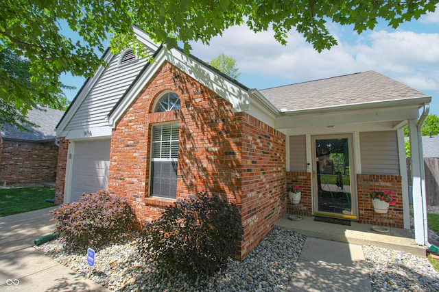 9774 Foxboro Ln, Fishers, IN 46038 - property entrance with brick siding, a garage, and a shingled roof