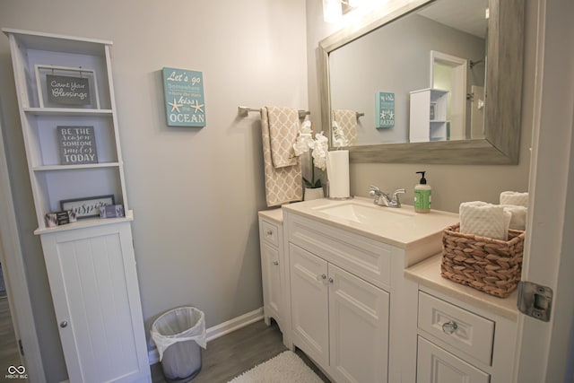 9774 Foxboro Ln, Fishers, IN 46038 - bathroom featuring vanity, wood finished floors, and baseboards