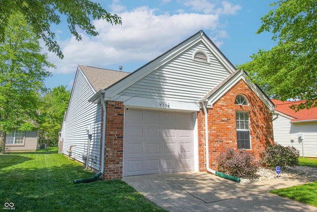 9774 Foxboro Ln, Fishers, IN 46038 - view of front of property with a garage, brick siding, concrete driveway, and a front yard