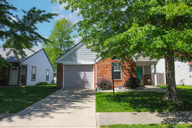 9774 Foxboro Ln, Fishers, IN 46038 - obstructed view of property with brick siding, an attached garage, driveway, and a front lawn
