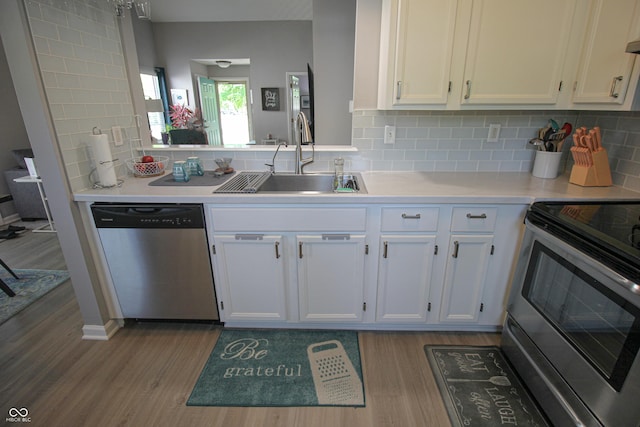 9774 Foxboro Ln, Fishers, IN 46038 - kitchen featuring appliances with stainless steel finishes, a sink, wood finished floors, and light countertops