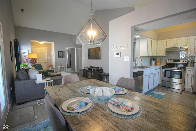 9774 Foxboro Ln, Fishers, IN 46038 - dining space with vaulted ceiling and dark wood-style flooring