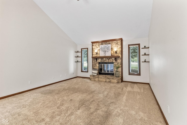 7426 N Carroll Rd, Indianapolis, IN 46236 - unfurnished living room with carpet, plenty of natural light, a stone fireplace, and high vaulted ceiling