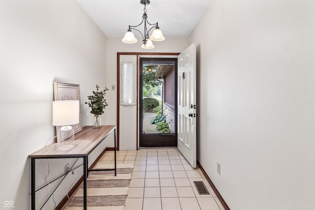 7426 N Carroll Rd, Indianapolis, IN 46236 - entryway featuring a chandelier and light tile patterned floors