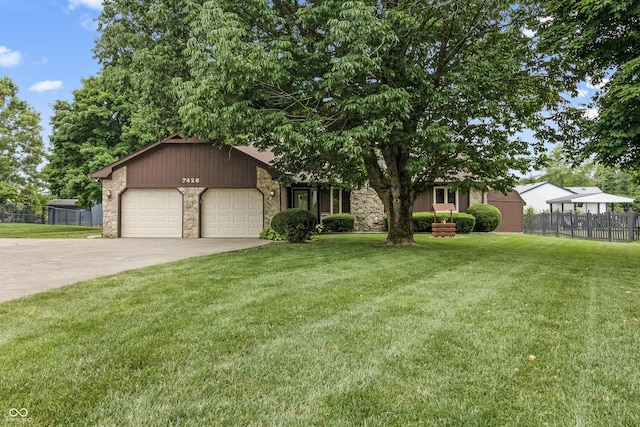 7426 N Carroll Rd, Indianapolis, IN 46236 - view of front of home featuring stone siding, a garage, and driveway